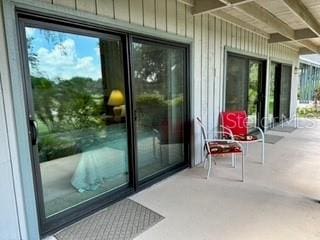 133 Palm View Ct Unit 3513/4, Haines City, FL 33844 - doorway featuring beam ceiling and wood walls
