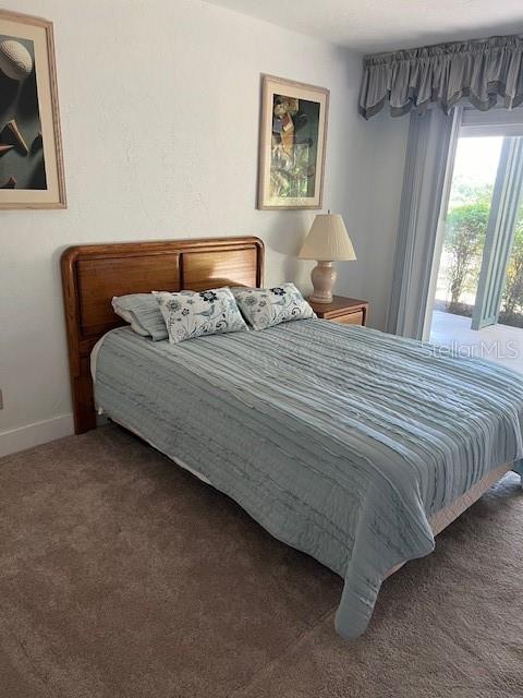 133 Palm View Ct Unit 3513/4, Haines City, FL 33844 - bedroom with carpet flooring and baseboards