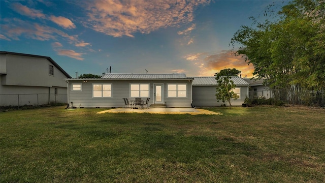 900 Lake Jessie Dr, Winter Haven, FL 33881 - back of house at dusk featuring metal roof and a patio area
