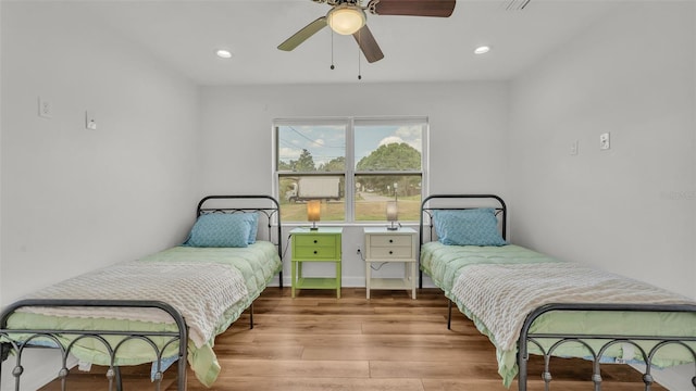 900 Lake Jessie Dr, Winter Haven, FL 33881 - bedroom with wood finished floors, recessed lighting, and a ceiling fan