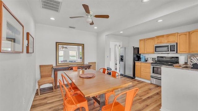 900 Lake Jessie Dr, Winter Haven, FL 33881 - kitchen with stainless steel appliances, light brown cabinets, light wood-style floors, ceiling fan, and recessed lighting