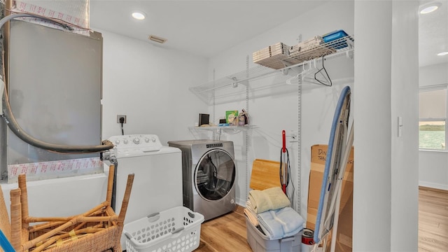 900 Lake Jessie Dr, Winter Haven, FL 33881 - laundry area with independent washer and dryer, wood finished floors, and recessed lighting