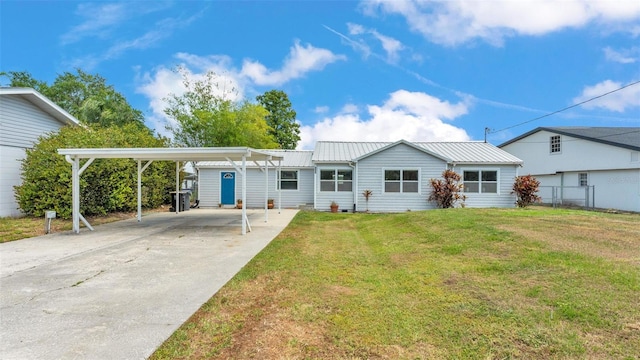 900 Lake Jessie Dr, Winter Haven, FL 33881 - back of house featuring concrete driveway, a carport, and metal roof