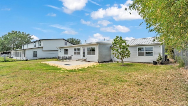 900 Lake Jessie Dr, Winter Haven, FL 33881 - rear view of house featuring a patio area and metal roof