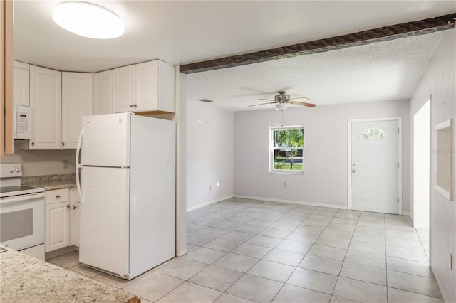 1163 Lake Dr, Lake Wales, FL 33859 - kitchen with white appliances, a ceiling fan, white cabinets, and light tile patterned floors