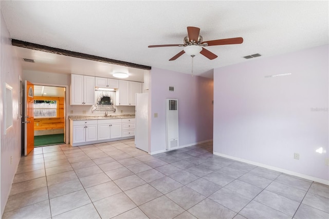 1163 Lake Dr, Lake Wales, FL 33859 - unfurnished living room with a ceiling fan, a sink, light tile patterned floors, and baseboards