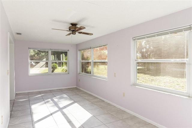 1163 Lake Dr, Lake Wales, FL 33859 - spare room featuring a ceiling fan, light tile patterned floors, and baseboards