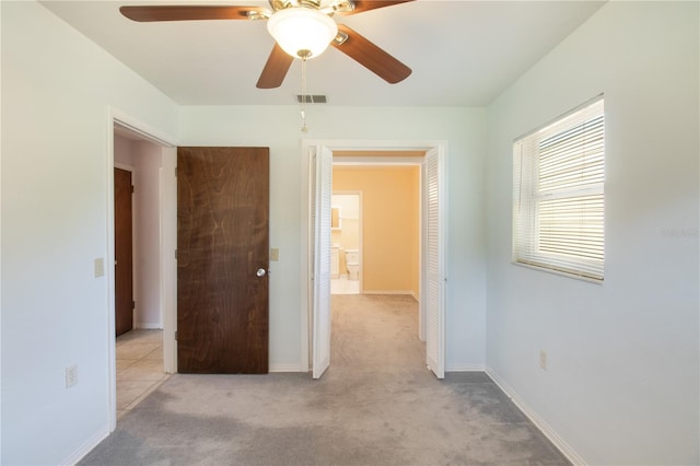 1163 Lake Dr, Lake Wales, FL 33859 - unfurnished bedroom featuring light colored carpet, ceiling fan, and baseboards