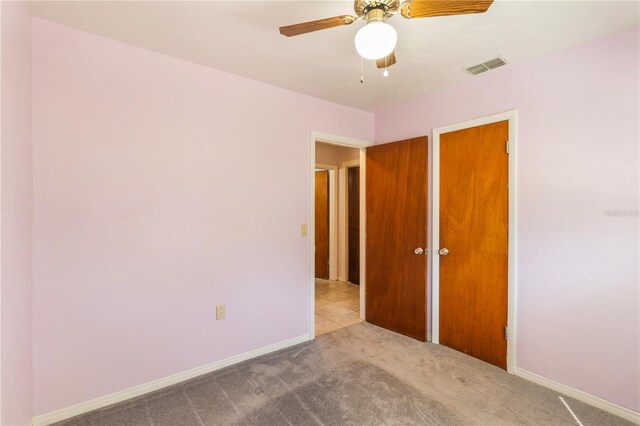 1163 Lake Dr, Lake Wales, FL 33859 - unfurnished bedroom with carpet, baseboards, and ceiling fan