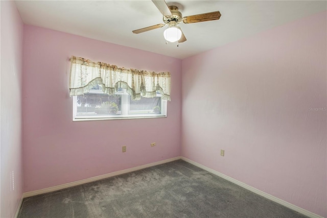 1163 Lake Dr, Lake Wales, FL 33859 - empty room with dark carpet, a ceiling fan, and baseboards