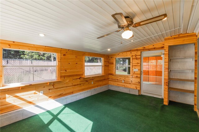 1163 Lake Dr, Lake Wales, FL 33859 - empty room featuring vaulted ceiling, wooden walls, carpet, and ceiling fan