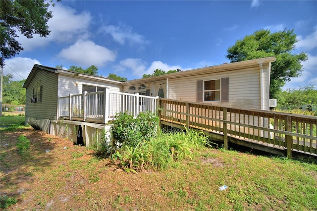 1294 1/2 38th St NW, Winter Haven, FL 33881 - rear view of property featuring a wooden deck
