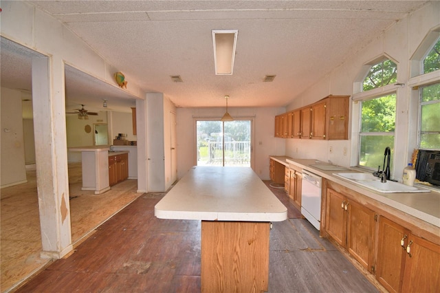 1294 1/2 38th St NW, Winter Haven, FL 33881 - kitchen with dishwasher, dark wood finished floors, a sink, a kitchen island, and light countertops