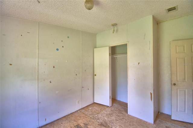 1294 1/2 38th St NW, Winter Haven, FL 33881 - unfurnished bedroom with a textured ceiling and a closet