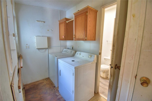 1294 1/2 38th St NW, Winter Haven, FL 33881 - washroom with washer and clothes dryer, cabinet space, and light wood-style floors