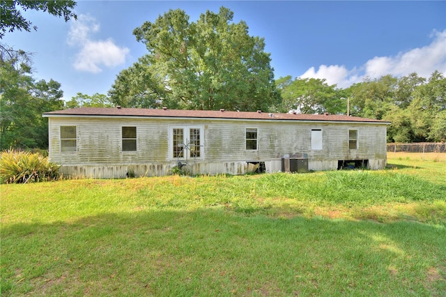 1294 1/2 38th St NW, Winter Haven, FL 33881 - rear view of house with french doors and a lawn