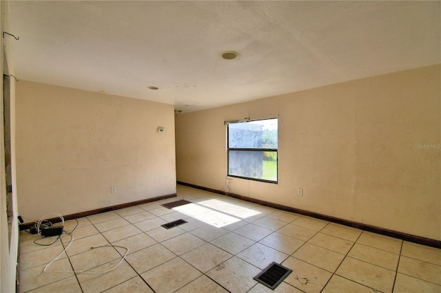 1294 1/2 38th St NW, Winter Haven, FL 33881 - unfurnished room with light tile patterned flooring and baseboards