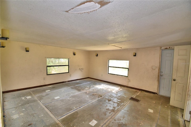 1294 1/2 38th St NW, Winter Haven, FL 33881 - spare room featuring a textured ceiling and baseboards