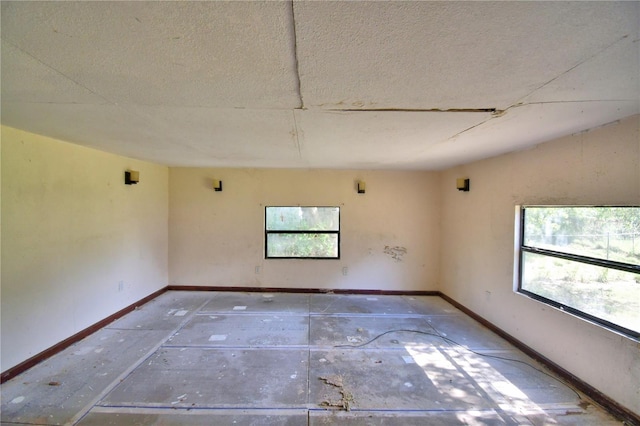 1294 1/2 38th St NW, Winter Haven, FL 33881 - spare room featuring a textured ceiling and baseboards
