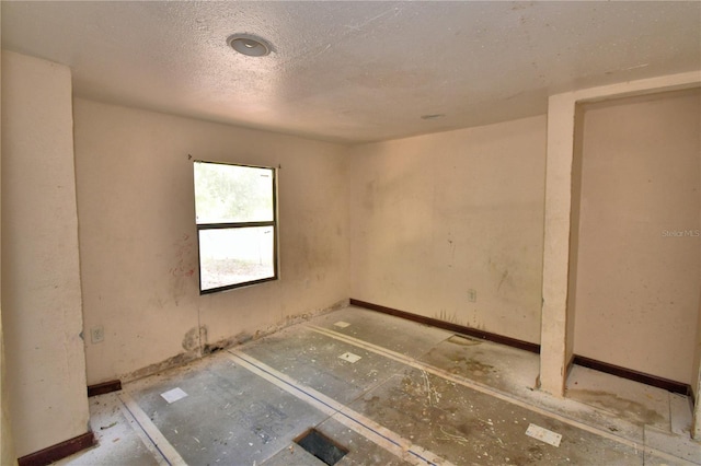 1294 1/2 38th St NW, Winter Haven, FL 33881 - spare room with baseboards and a textured ceiling