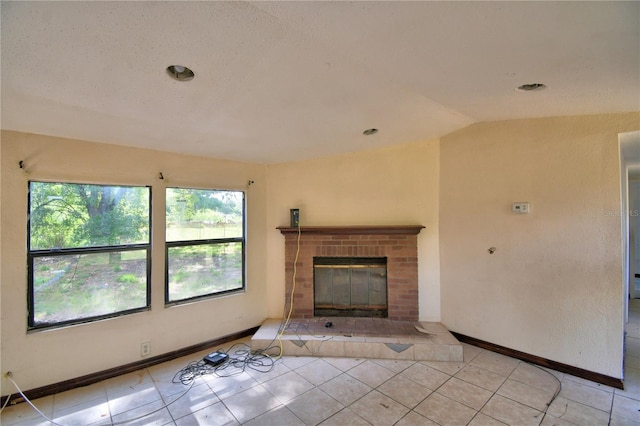 1294 1/2 38th St NW, Winter Haven, FL 33881 - unfurnished living room featuring tile patterned floors, lofted ceiling, baseboards, and a brick fireplace