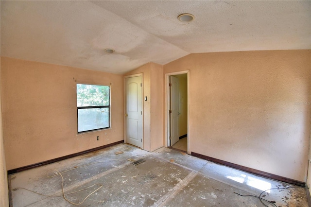 1294 1/2 38th St NW, Winter Haven, FL 33881 - unfurnished room featuring vaulted ceiling and baseboards