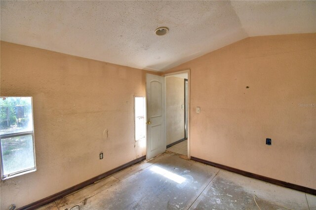 1294 1/2 38th St NW, Winter Haven, FL 33881 - spare room with lofted ceiling, plenty of natural light, and baseboards