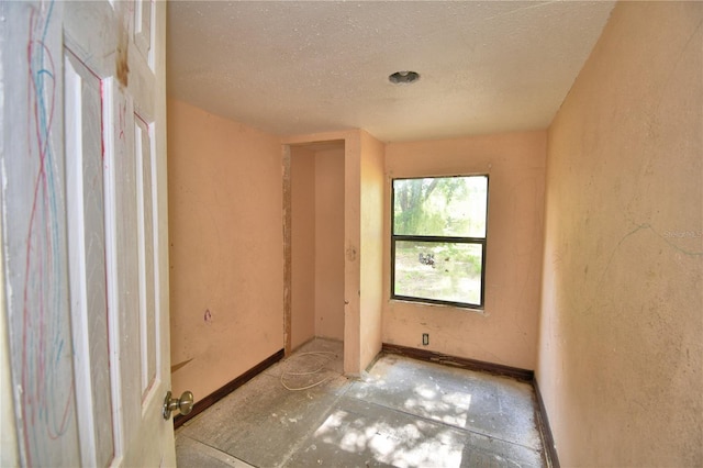 1294 1/2 38th St NW, Winter Haven, FL 33881 - empty room featuring a textured ceiling, baseboards, and a textured wall