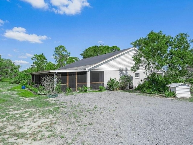 rear view of property featuring a sunroom