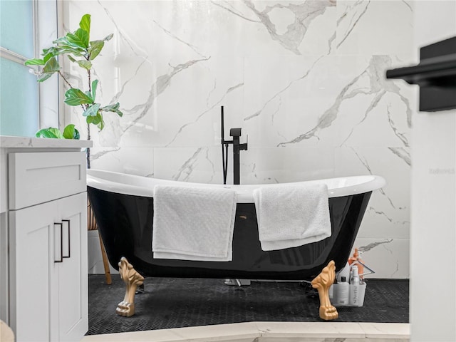 full bath featuring a freestanding bath and tile walls