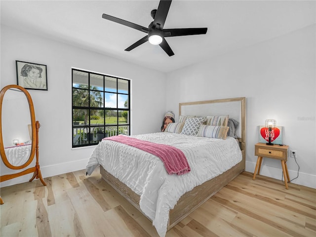 bedroom with wood finished floors, baseboards, and ceiling fan
