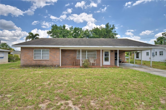780 Oleander Dr SE, Winter Haven, FL 33880 - ranch-style home featuring brick siding, a front lawn, concrete driveway, and an attached carport