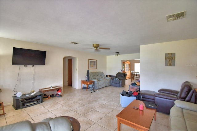 780 Oleander Dr SE, Winter Haven, FL 33880 - living room with arched walkways, ceiling fan, and light tile patterned flooring