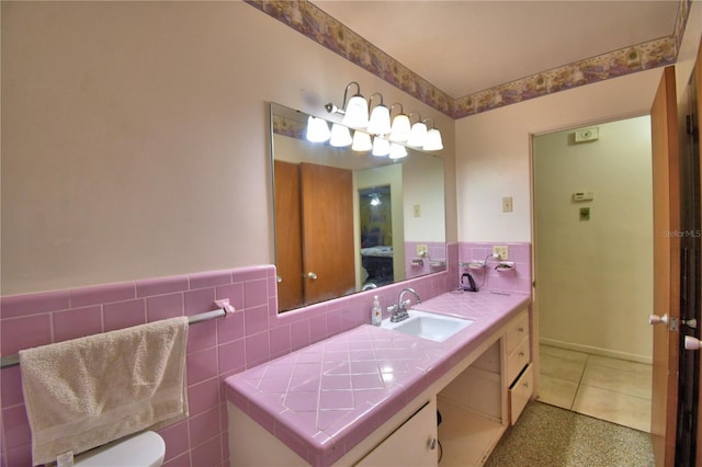 780 Oleander Dr SE, Winter Haven, FL 33880 - bathroom featuring tile walls, wainscoting, ensuite bath, and vanity