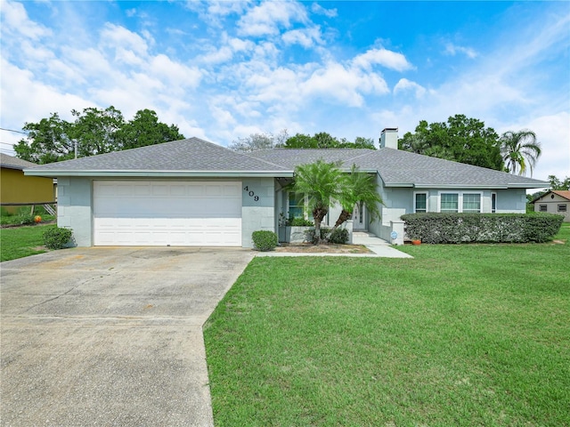409 N 6th St, Lake Hamilton, FL 33851 - ranch-style home featuring concrete driveway, a front lawn, a chimney, and a garage