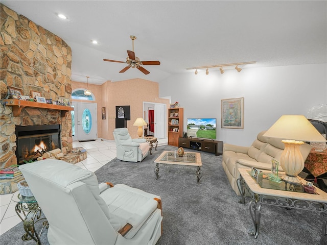 409 N 6th St, Lake Hamilton, FL 33851 - living area featuring a ceiling fan, tile patterned flooring, a stone fireplace, and high vaulted ceiling