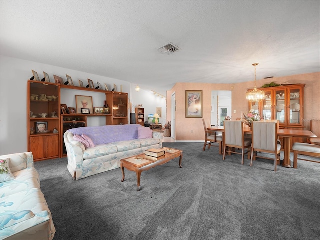 409 N 6th St, Lake Hamilton, FL 33851 - living room featuring carpet flooring, a chandelier, and a textured ceiling