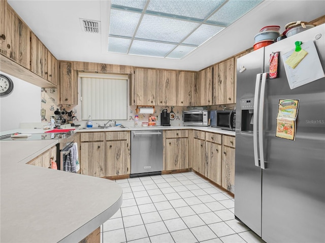 409 N 6th St, Lake Hamilton, FL 33851 - kitchen with appliances with stainless steel finishes, light countertops, a sink, and light tile patterned floors