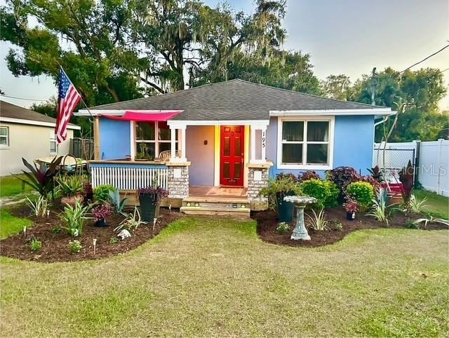 bungalow-style home with a shingled roof and stucco siding