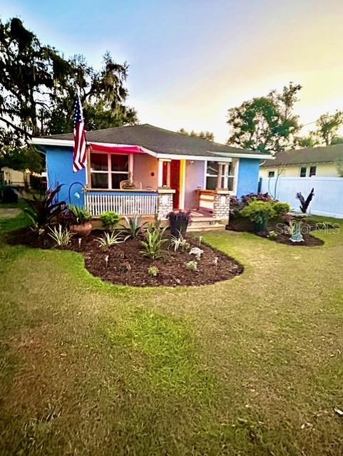 single story home with a front lawn and stucco siding