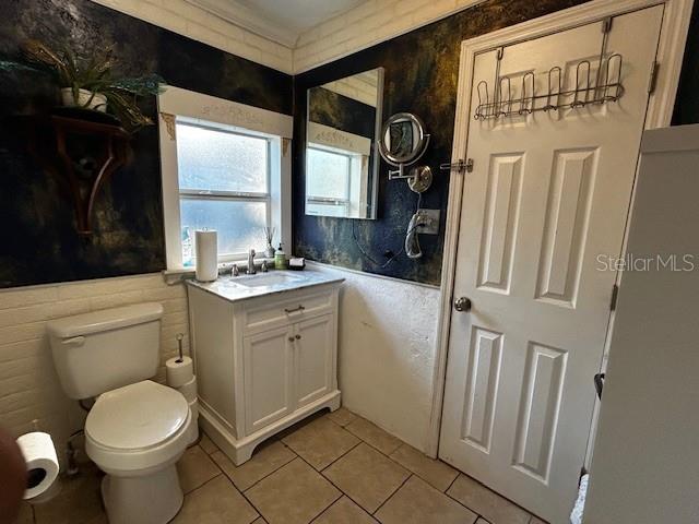 bathroom with tile patterned flooring, toilet, and vanity