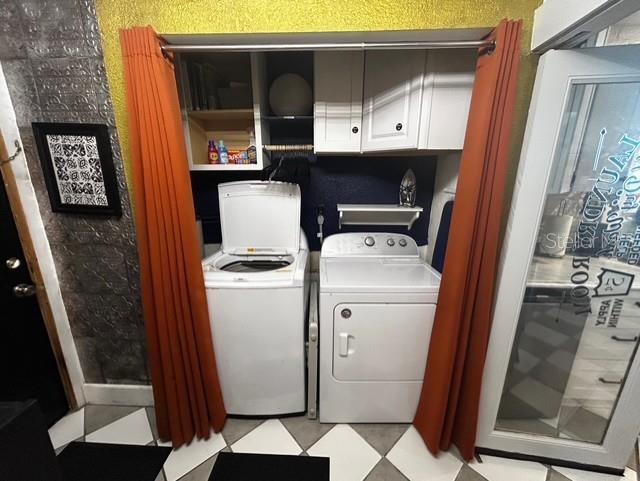 washroom with washing machine and clothes dryer