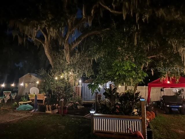yard at twilight featuring a storage unit