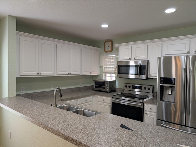4488 Turnberry Ln, Lake Wales, FL 33859 - kitchen with appliances with stainless steel finishes, a sink, white cabinetry, and recessed lighting