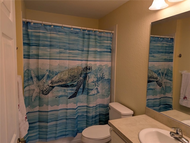 4488 Turnberry Ln, Lake Wales, FL 33859 - bathroom with a textured wall, vanity, toilet, and curtained shower