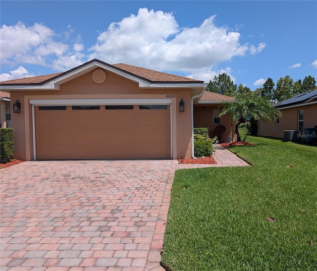 4488 Turnberry Ln, Lake Wales, FL 33859 - single story home featuring decorative driveway, stucco siding, a front lawn, and a garage