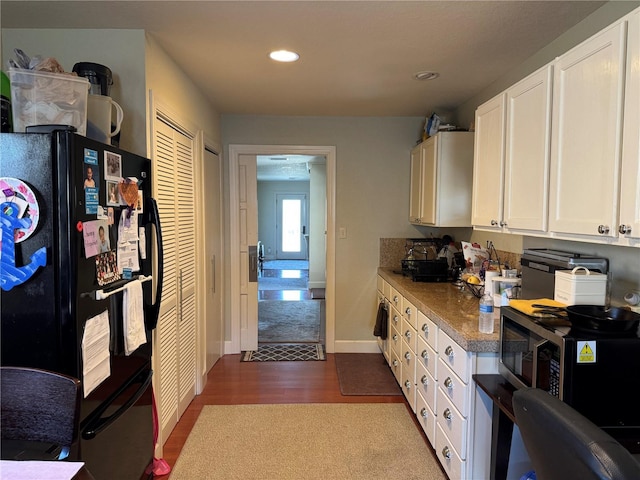 836 41st Ave N, Saint Petersburg, FL 33703 - kitchen with freestanding refrigerator, white cabinets, stainless steel microwave, recessed lighting, and dark wood-style flooring