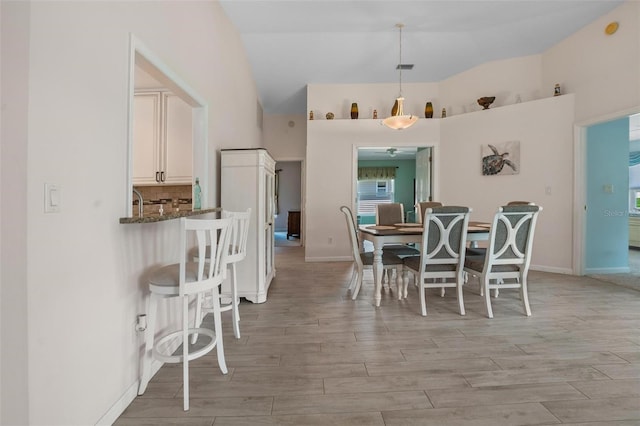 4005 Carter Creek Dr, Avon Park, FL 33825 - dining area featuring light wood-style flooring, high vaulted ceiling, baseboards, and a ceiling fan