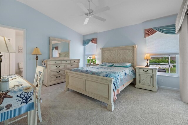 4005 Carter Creek Dr, Avon Park, FL 33825 - bedroom with vaulted ceiling, light colored carpet, baseboards, ceiling fan, and ensuite bathroom