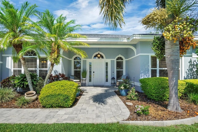 109 Lake Mariam Way, Winter Haven, FL 33884 - doorway to property with stucco siding